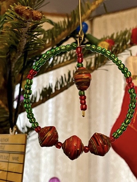 Tree ornament - round and made from green, red and brown beads.
